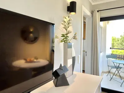 a television sitting on a table in a living room at Porto Marina - City center by HD PROPERTIES in Vilamoura