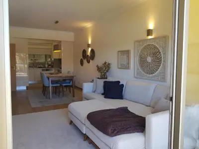a living room with a bed and a dining room at MARINA DE ALBUFEIRA, Best Apartment in Albufeira