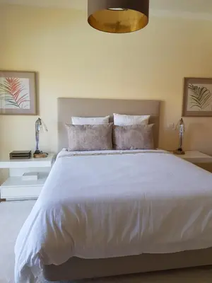 a bedroom with a large white bed with pillows at MARINA DE ALBUFEIRA, Best Apartment in Albufeira