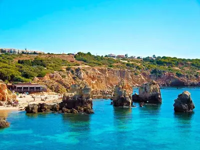 a view of a beach with rocks in the water at Cozy Townhouse Vila Rafaella2 near São Rafael Beach Albufeira in Albufeira