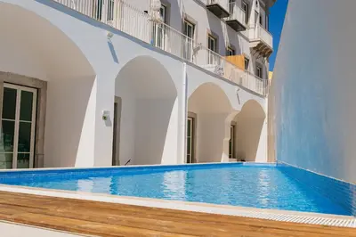 a swimming pool on the side of a building at Algarve Sweetness Apartment in Faro