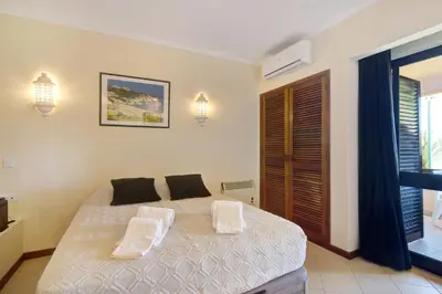 a bedroom with a bed with two pillows on it at Belavista House in Albufeira