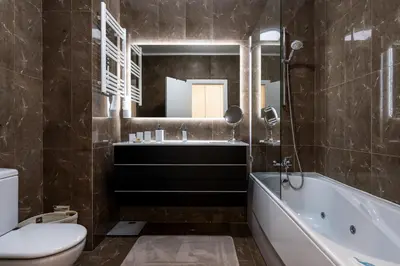 a bathroom with a tub and a bedroom at Love Nest Algarve Edition vilamoura in Vilamoura