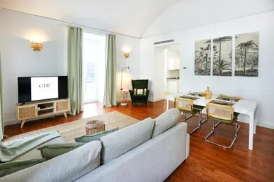 a living room with a couch and a table at Coast Guard Apartment in Faro