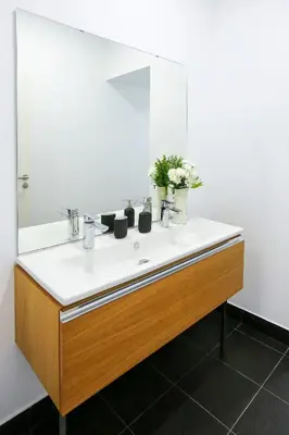 a bathroom with a sink and a mirror at Coast Guard Apartment in Faro