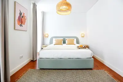 a bedroom with a bed with a large window at Endless Summer Apartment in Faro