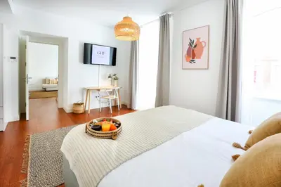 a bedroom with a bed with a bowl of fruit on it at Endless Summer Apartment in Faro