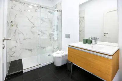 a bathroom with a shower and a sink and a toilet at Endless Summer Apartment in Faro
