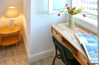 a living room with a kitchen with a counter top at Hot Breeze Apartment in Faro