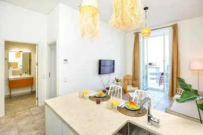 a balcony with a table and chairs and a swimming pool at Hot Breeze Apartment in Faro