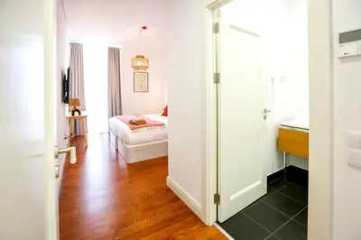a room with a bedroom with a bed and a door at Faro Away From Home Apartment in Faro