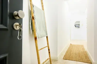 a ladder leaning against a wall next to a door at Faro Away From Home Apartment in Faro