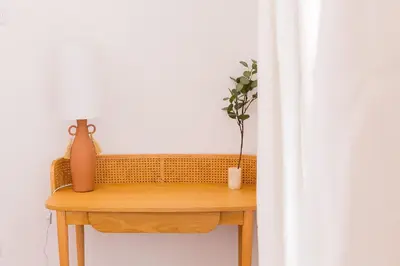 a table with a vase and a plant on it at President Pais Apartment in Faro