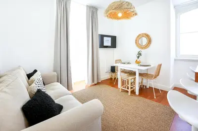 a living room with a white couch and a table at Salty Spot Apartment in Faro