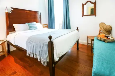 a bedroom with a large bed with a wooden headboard at Jump Into the Lull Apartment in Faro
