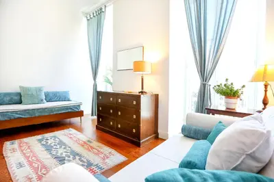 a living room with a couch and a table at Jump Into the Lull Apartment in Faro