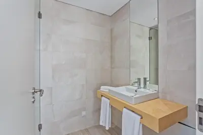 a bathroom with a sink and a mirror at Balaia Senses in Albufeira