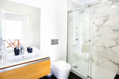 a bathroom with a shower and a sink and a toilet at Young Spirit Apartment in Faro