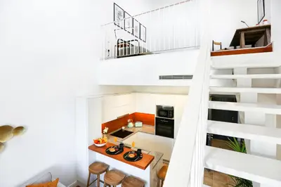 an open kitchen and staircase in a house at Young Spirit Apartment in Faro