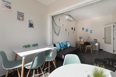a living room with a table and chairs at Lemon Hostel Faro in Faro