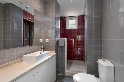 a bathroom with a sink and a toilet and a mirror at Lemon Hostel Faro in Faro