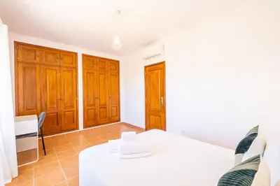 a room with a white table and wooden cabinets at Villa Jasmin - Galé Bay in Albufeira
