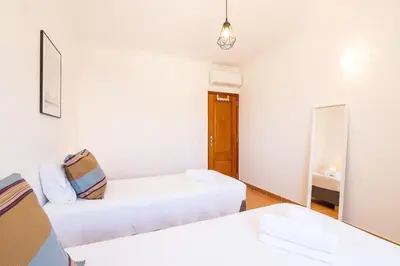 a white room with two beds and a mirror at Villa Jasmin - Galé Bay in Albufeira