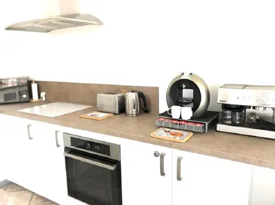 a kitchen counter with a microwave and a coffee maker at The Albufeira Concierge - Moinho Pool & Gardens in Albufeira