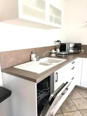a kitchen counter with a sink and a microwave at The Albufeira Concierge - Moinho Pool & Gardens in Albufeira