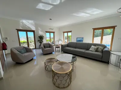 a living room with a couch and a table at Light House Luxury Villa in Albufeira