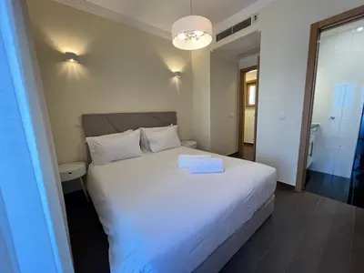 a bedroom with a white bed with a white box on it at Light House Luxury Villa in Albufeira