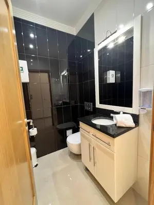 a bathroom with a toilet and a sink and a mirror at Light House Luxury Villa in Albufeira
