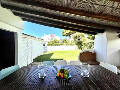 a wooden table with a bowl of fruit on it at Vilamoura Traditional Villa with Pool by Homing in Vilamoura