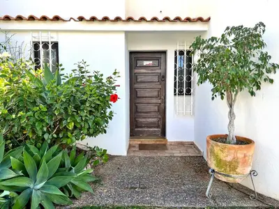 a front door of a house with a tree at Vilamoura Traditional Villa with Pool by Homing in Vilamoura