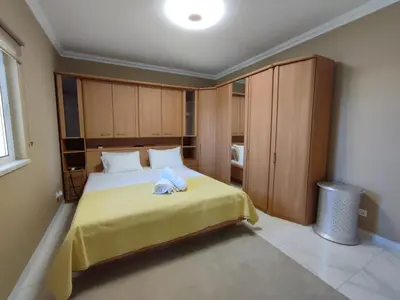 a bedroom with a bed with a teddy bear on it at Casa das Oliveiras o seu refugio no Algarve in Quarteira