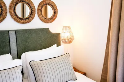 a bedroom with a bed and mirrors on the wall at Offline Mood Apartment in Faro