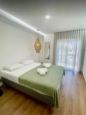 a bedroom with a large bed with two towels on it at Pontinha Exclusive Apartment in Faro