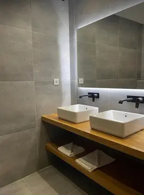 a bathroom with two sinks and a mirror at Pontinha Exclusive Apartment in Faro