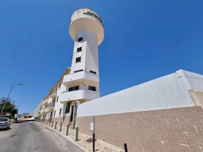 a lighthouse on the side of a building at Torre da Aldeia by Umbral in Albufeira