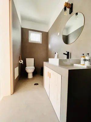 a bathroom with a sink and a toilet and a mirror at Amazing - VillaAnas Balaia in Albufeira