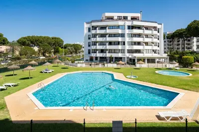 a large swimming pool in front of a building at TENNIS GOLF MAR - Apartamento renovado para 4 com AC e piscina in Vilamoura