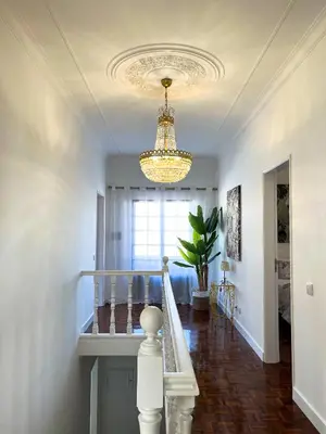 a hallway with a chandelier and stairs in a house at Sunshine Villa with Heated Pool in Faro