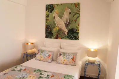 a bedroom with a bed with a painting on the wall at Sunshine Villa with Heated Pool in Faro