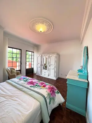 a bedroom with a large bed and a blue dresser at Sunshine Villa with Heated Pool in Faro