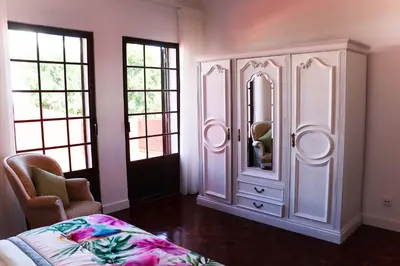 a large white cabinet in a room with windows at Sunshine Villa with Heated Pool in Faro