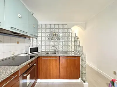 a kitchen with a sink and a microwave at Albufeira Cosy by Homing in Albufeira