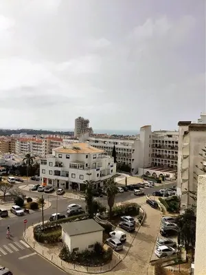 a city with cars parked in a parking lot at 1 Bedroom Apartment Chaves, Praceta Vitorino Nemesio, Albufeira in Albufeira