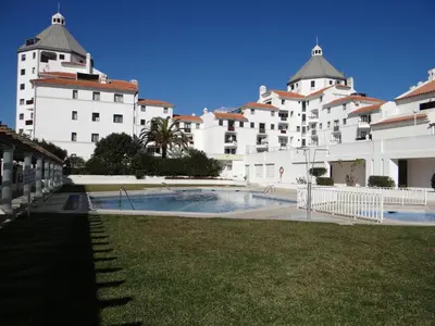 a large building with a swimming pool in front of it at Porto Marina @Vilamoura in Vilamoura