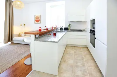 a kitchen with white cabinets and a counter top at Ice Cream Call Apartments in Faro