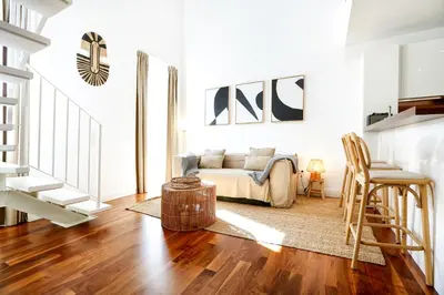 a living room with a couch and a table at Vacation Time Apartment in Faro